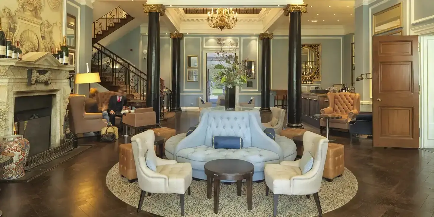 A luxurious hotel lounge with elegant seating and large windows.