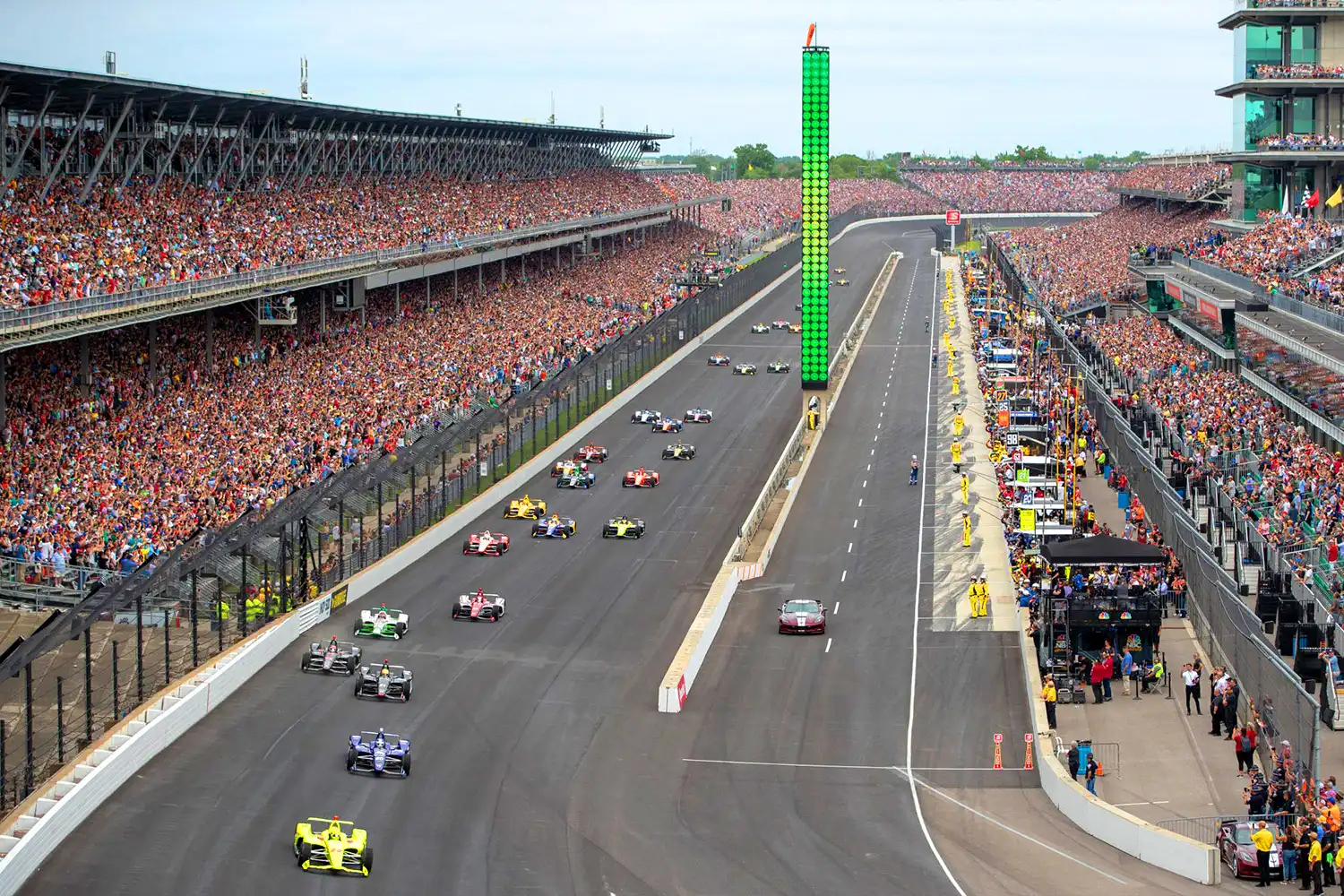 IndyCars racing at high speed on the famous Indianapolis Motor Speedway.