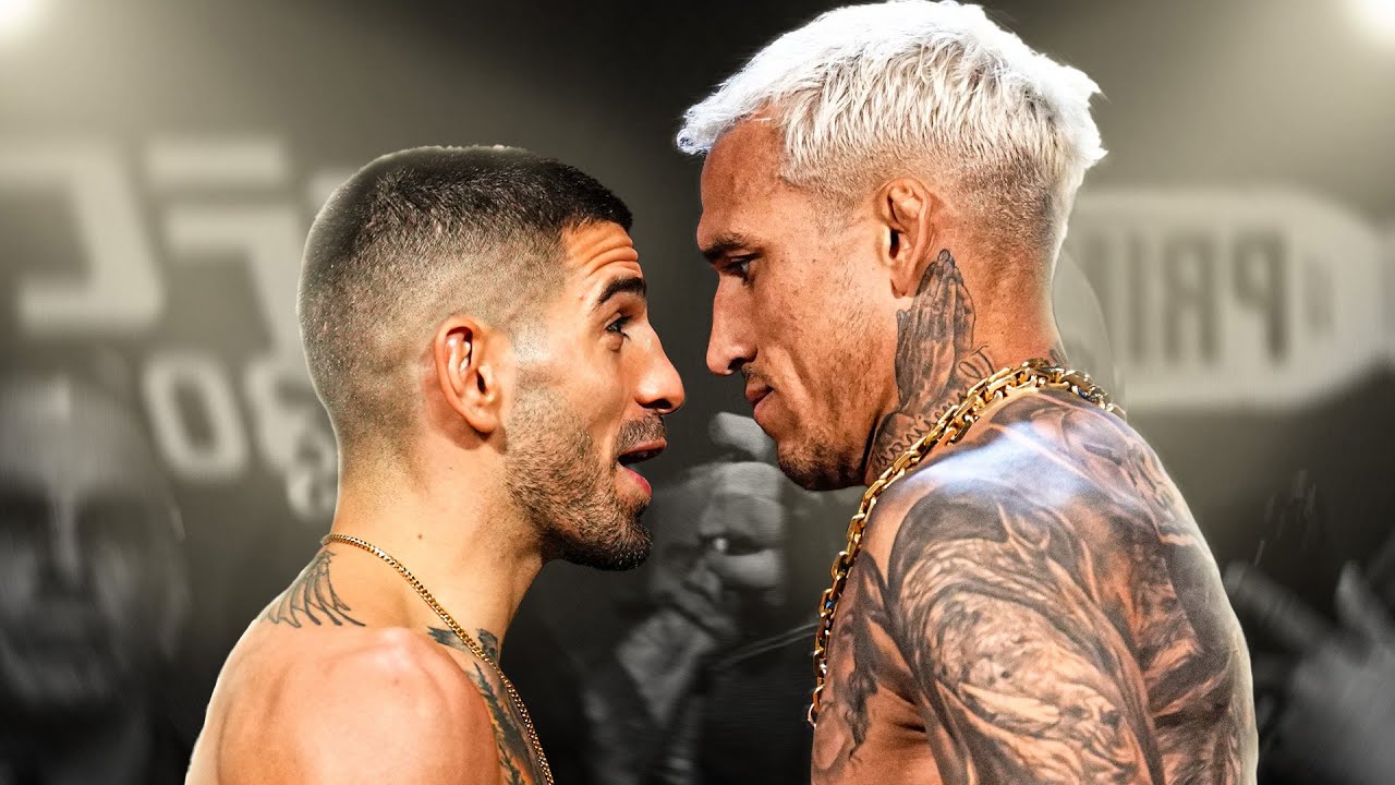 Ilia Topuria and Charles Oliveira facing off in the Octagon before UFC 317