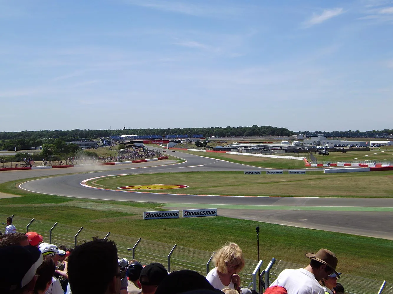 A dynamic shot of an F1 car navigating the iconic Maggotts and Becketts complex.