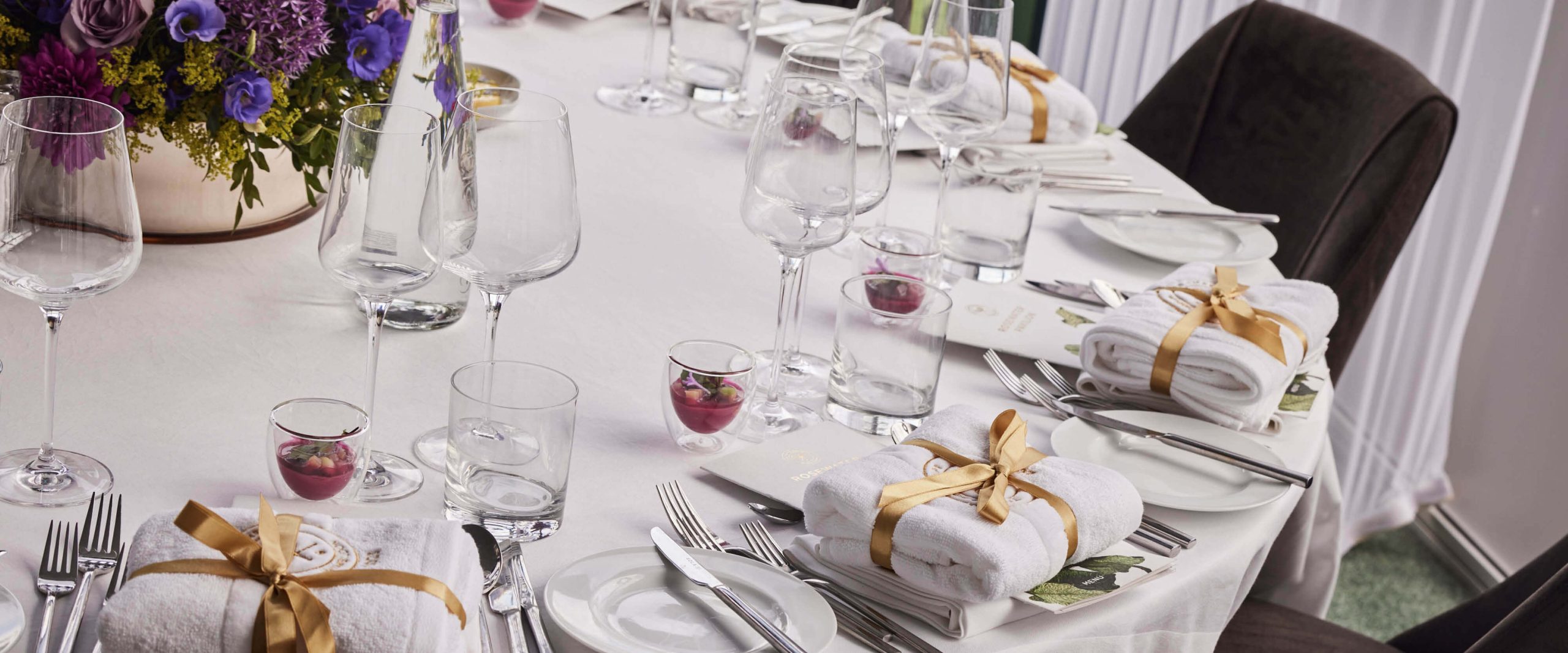 A detailed view of the luxurious table settings in the private suite.
