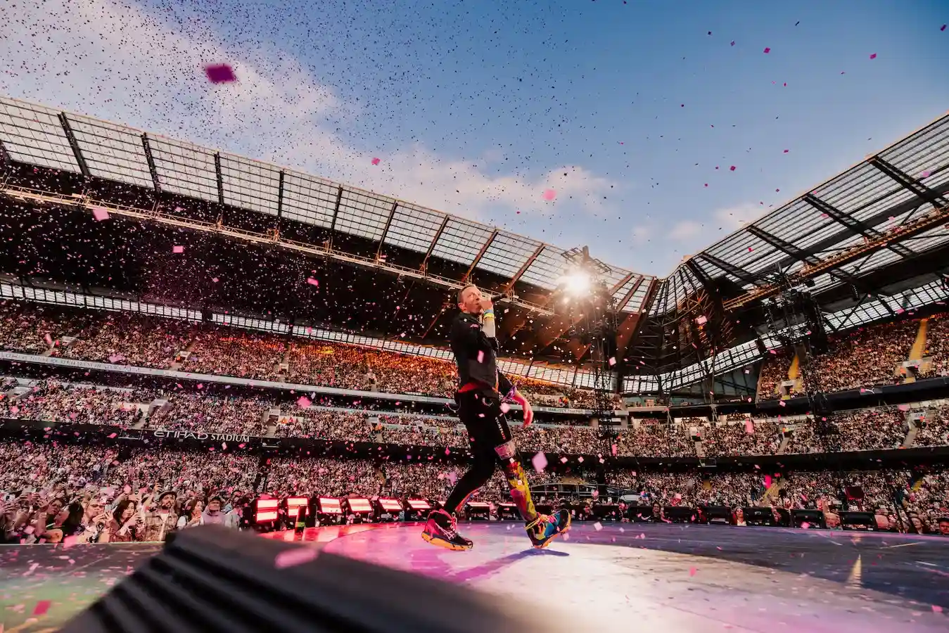 A vibrant concert scene at the Etihad Stadium in Manchester
